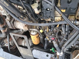 Телескопичен товарач Caterpillar TH407C, снимка 12